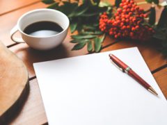 Cup of coffee, pen, paper and pen