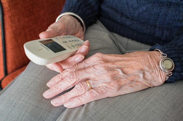 Older person using a cellphone, senior, debt