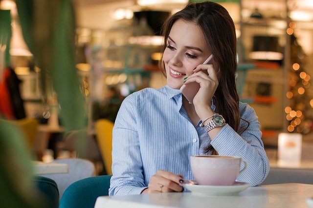 Woman on phone, coffee cup